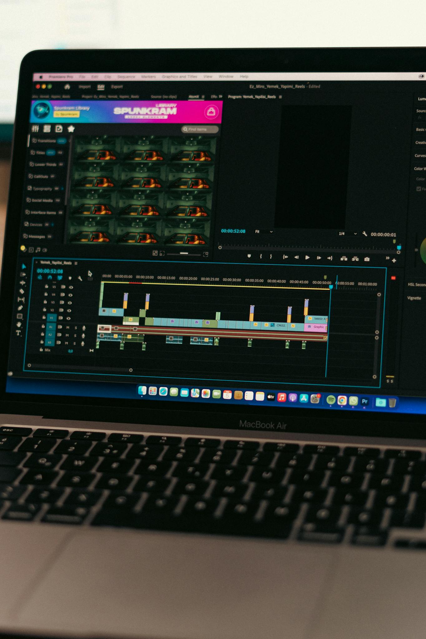 Close-up of video editing software on a MacBook Air screen, showcasing a digital workspace.